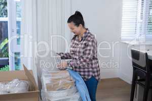 Woman unpacking boxes in new home