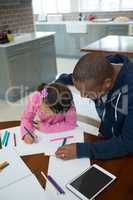 Father helps his daughter with her school homework