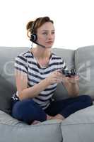 Woman in headphones playing video game