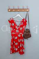 Red dress and bag hanging on hook