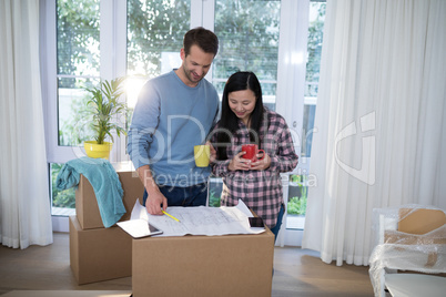 Couple looking at the blueprint of their new home