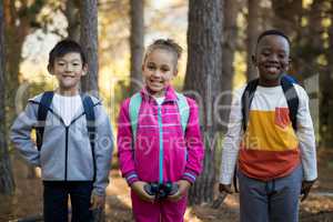 Portrait of happy kids holding binoculars