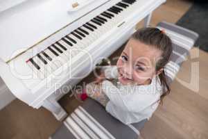Overhead of cute girl playing piano