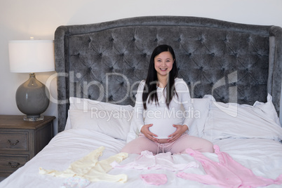 Portrait of woman feeling the presence of baby in stomach