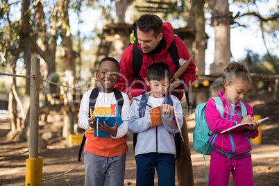 Teacher assisting kids in studying