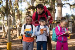 Teacher assisting kids in studying