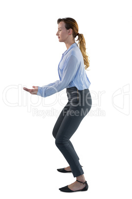 Female executive pretending to hold an invisible object