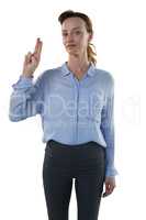 Female executive pretending to use an invisible screen