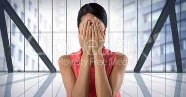 Businesswoman covering eyes with hand in city office