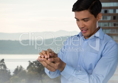 Businessman with hands palm together in city