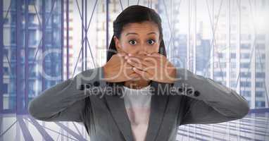 Businesswoman covering mouth with hand in city office