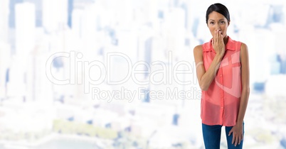 Businesswoman covering mouth with hand in city