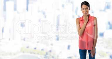 Businesswoman covering mouth with hand in city