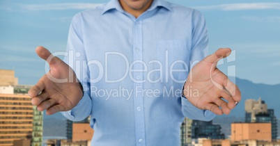 Businessman with hands palm open in city