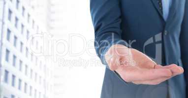 Businessman with hand palm open in city