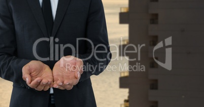 Businessman with hands palm open in city