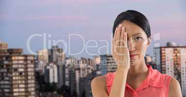 Businesswoman covering eye with hand in city