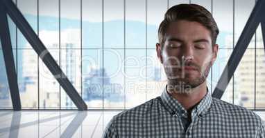 Businessman with eyes closed in city office