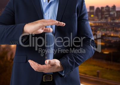 Businessman with hands palm open in city at evening