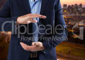 Businessman with hands palm open in city at evening