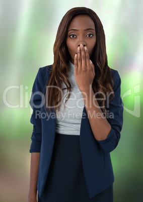 Businesswoman covering mouth with hand in nature