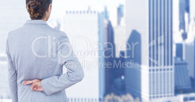 Businesswoman crossing fingers in city Businesswoman crossing fingers in city