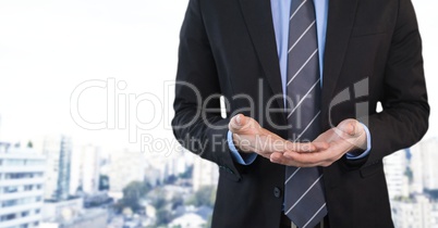 Businessman with hands palm open in city