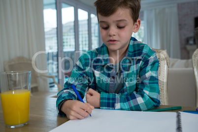 Boy doing homework at table