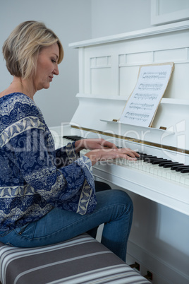 Beautiful woman playing piano