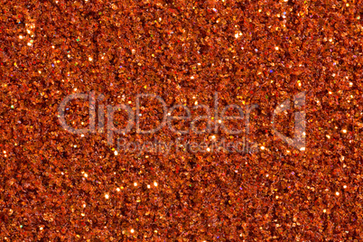 Saturated brick-colour background with glitter.