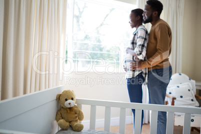 Couple standing together in bedroom