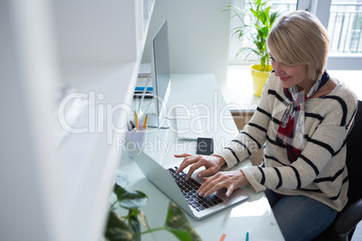 Woman using laptop at table