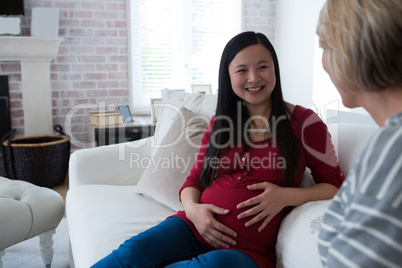 Female friends interacting with each other in living room