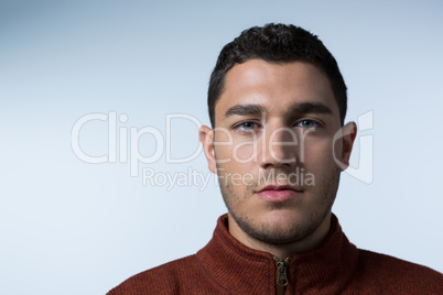 Man looking at camera against white background