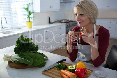 Beautiful woman having lemon tea at table