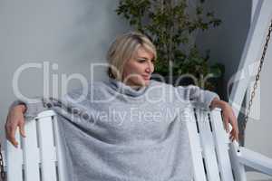 Thoughtful woman relaxing in porch