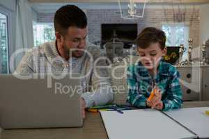 Father assisting son in his studies