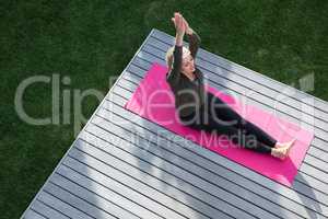 Overhead of woman practicing yoga in porch