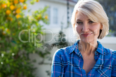 Portrait of happy woman standing in garden