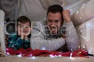 Happy father and son relaxing bedroom