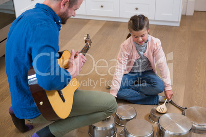 Father and daughter enjoying in kitchen