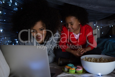 Mother and daughter using laptop