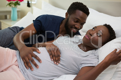 Man touching woman stomach in bedroom Man touching woman stomach in bedroom