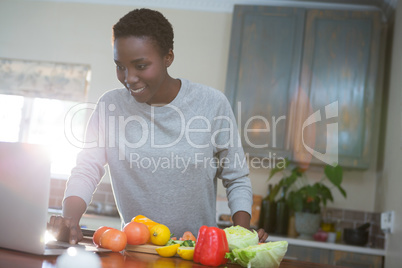 Beautiful woman learning food recipe from laptop