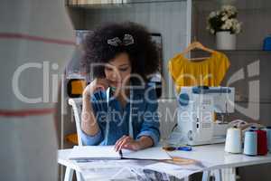 Female fashion designer working at desk