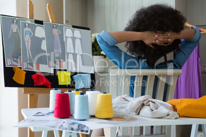 Female fashion designer relaxing on chair