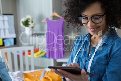 Female fashion designer using digital tablet