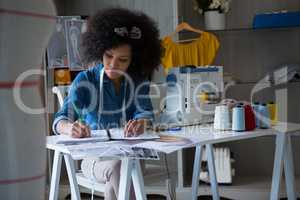 Female fashion designer working at desk