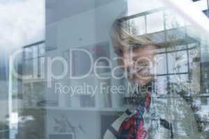 Beautiful woman looking through window