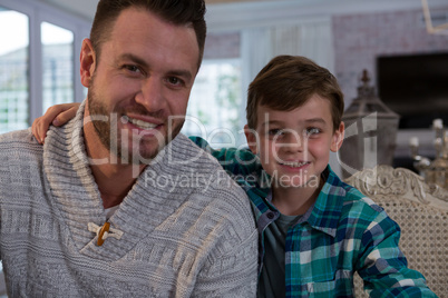 Happy father and son in living room